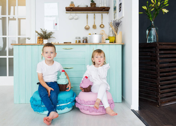Little brother and sister sit in home kitchen with model ice-cream. Horizontal portrait - Foto, Bild
