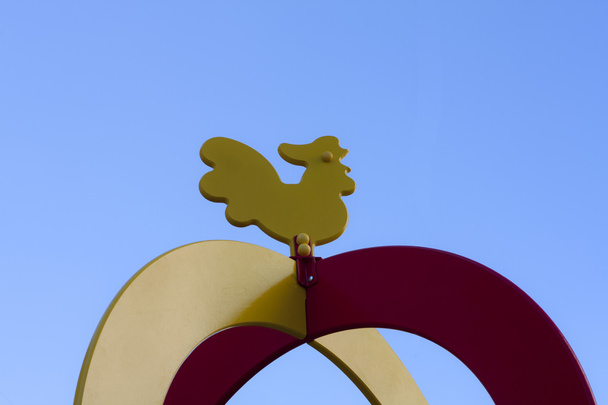 Wooden cockerel on the sky background - Photo, Image