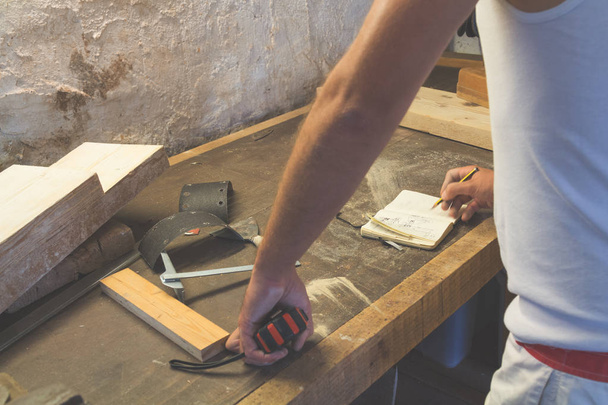 Carpenter while working at workshop.  - Photo, Image
