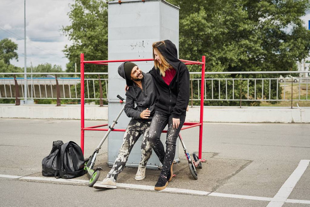 Young stylish couple posing on urban background  - Foto, imagen