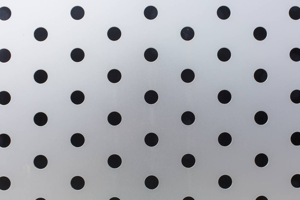 black circles on a metal surface pattern texture background - Photo, image