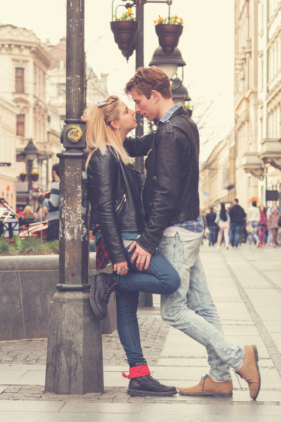 young woman looking at man and kissing at street - 写真・画像