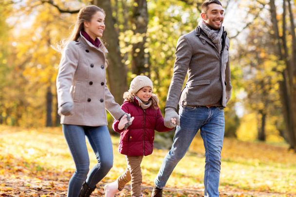 happy family walking at autumn park - Фото, изображение