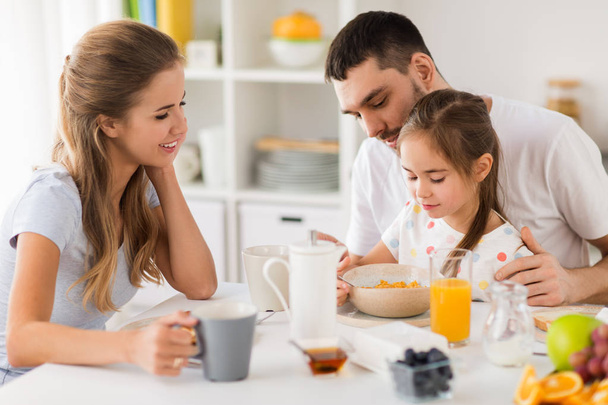 happy family having breakfast at home - Фото, зображення