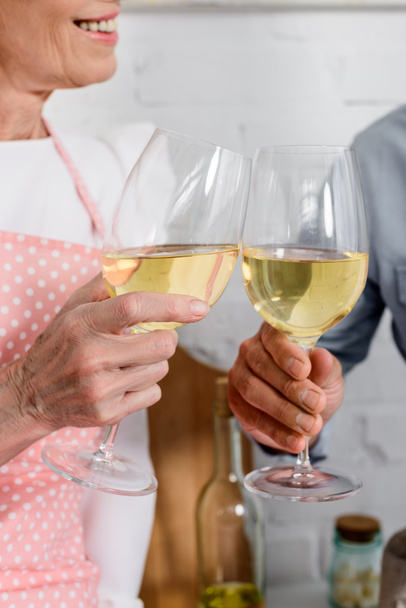 cropped shot of elederly couple clinking glasses of wine - Φωτογραφία, εικόνα