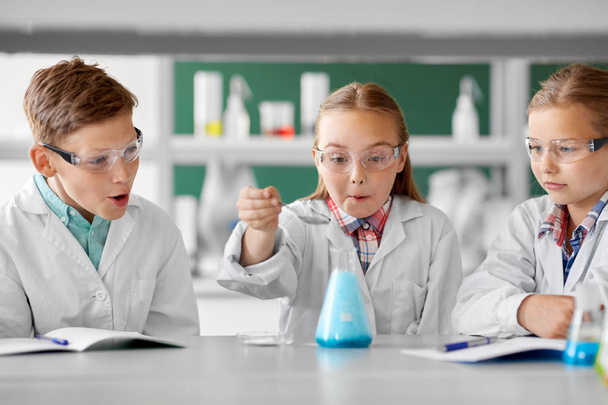 kids with test tube studying chemistry at school - Фото, изображение