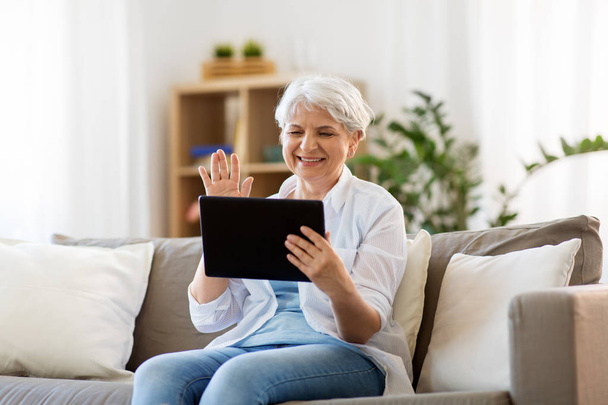 senior woman having video chat on tablet pc - Foto, immagini