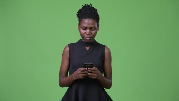 Young beautiful African businesswoman using phone - Materiał filmowy, wideo
