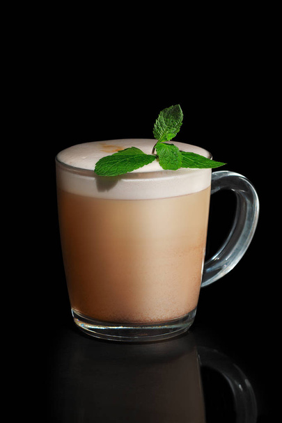 Transparent cup of mint Cappuccino isolated on black - Фото, изображение