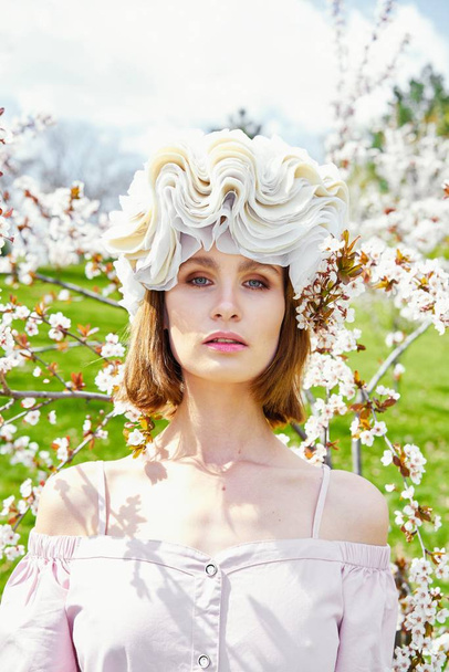 Gorgeous young woman in elegant headdress posing outdoors  - Fotografie, Obrázek