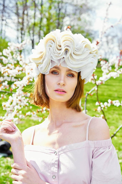 Gorgeous young woman in elegant headdress posing outdoors  - Foto, afbeelding
