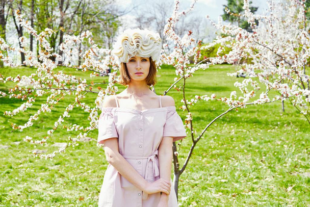 Gorgeous young woman in elegant headdress posing outdoors  - Foto, Imagen
