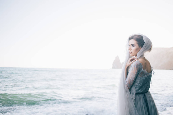 Horizontal photo of a beautiful bride woman on the beach. Fine art, copy space. Wedding inspiration - Φωτογραφία, εικόνα
