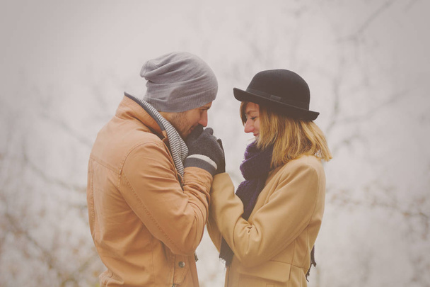 romantic man looking at girlfriend and kissing hands outdoor  - Fotó, kép