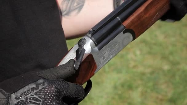 A close-up view of rifle. Mans hands demonstrates the principle of recharging a double-barrel rifle - Footage, Video