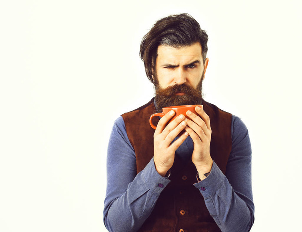 bearded man holding cup with coffee, tea with angry face - Фото, изображение