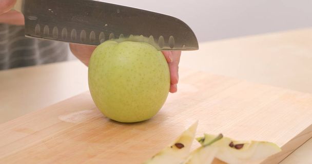 Cutting apple on wooden board - Foto, Imagem