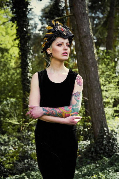 Gorgeous young woman in elegant headdress posing outdoors  - Fotoğraf, Görsel