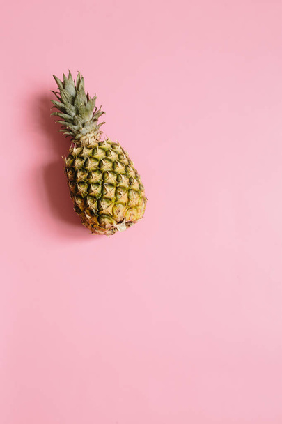 分離したパステル ピンク背景に熟したパイナップル。ミニマリスト スタイル トレンディな熱帯のコンセプトです。テキスト、コピー、レタリングのための部屋. - 写真・画像