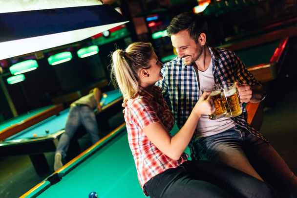 Young attractive couple together on date in snooker club - Fotografie, Obrázek