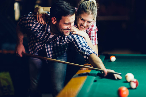 Young attractive couple playing snooker together in bar - Fotografie, Obrázek