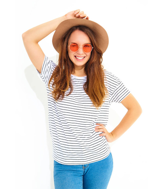 Portrait of young stylish laughing girl model in casual summer clothes in brown hat with natural makeup isolated on white background. Winking - Zdjęcie, obraz
