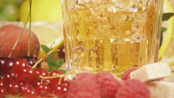 Slow motion drink a yellow color pour into a glass of ice - Imágenes, Vídeo