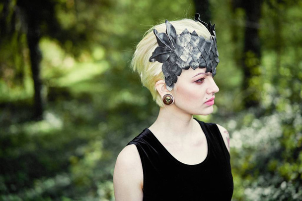 Gorgeous young woman in elegant headdress posing outdoors  - Fotografie, Obrázek