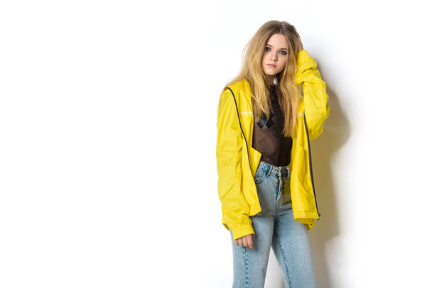 attractive young woman in transparent shirt and yellow jacket on white looking at camera - Fotoğraf, Görsel