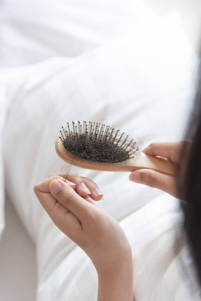 woman show her brush for presetation  hairloss problem and looking at her hair - Φωτογραφία, εικόνα