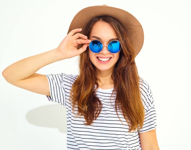 Portrait of young stylish laughing girl model in casual summer clothes in brown hat isolated on white background - Фото, зображення