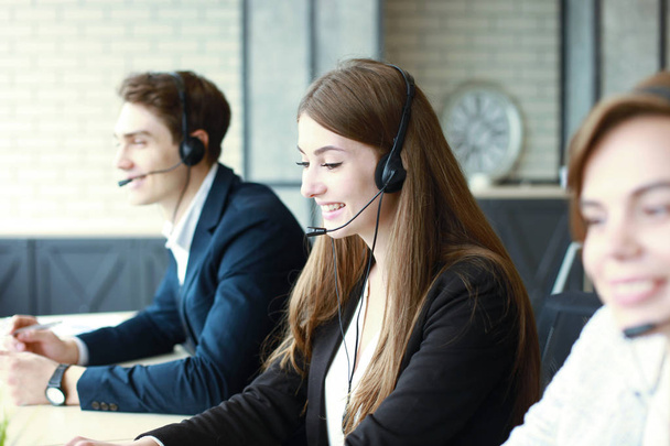 Attractive positive young businesspeople and colleagues in a call center office - Foto, Imagen