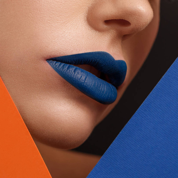 Close up of womans face with lips covered with dark blue lipstick. - Photo, image