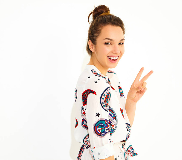 Smiling girl model in casual summer clothes, showing peace sign - Фото, изображение