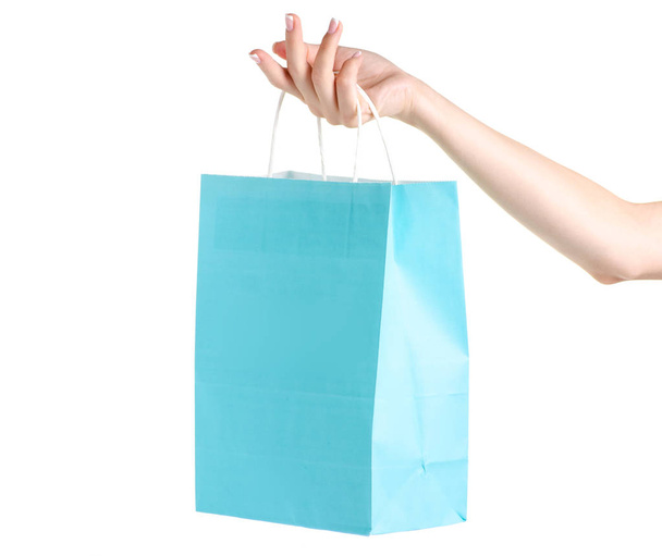 Blue turquoise paper package bag in hand shop shopping fashion - Foto, Imagem