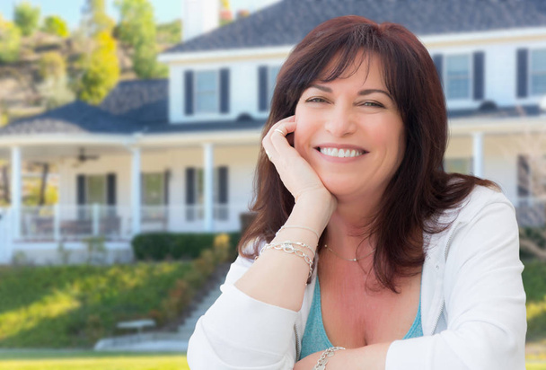 Attractive Middle Aged Woman Relaxing In Front Yard of Beautiful House. - Photo, Image
