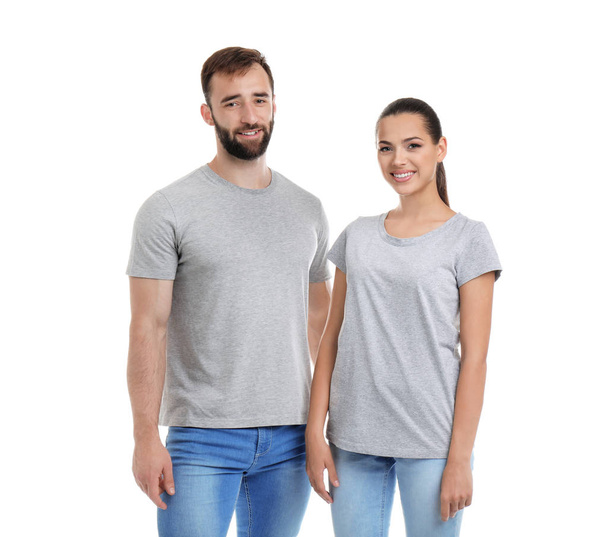 Young couple in t-shirts on white background. Mockup for design - Foto, afbeelding