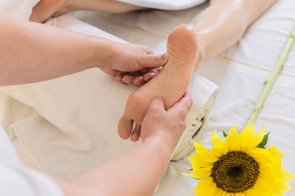 Kobieta enjoyingreflexology masaż stóp w wellness spa. - Zdjęcie, obraz