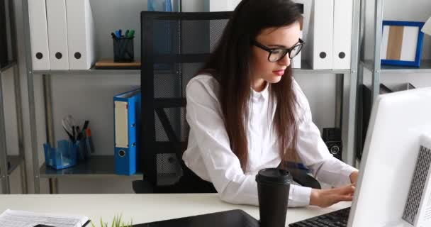 businesswoman taking off glasses,holding cup and smiling in modern office - Footage, Video
