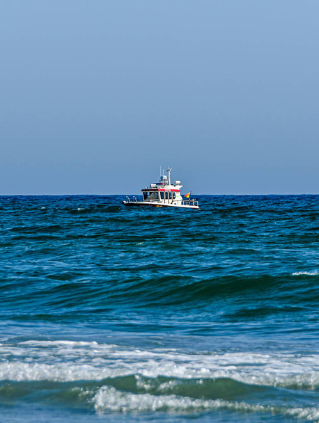 Boat near the Beach of Black Sea from Mamaia, Romania, blue clear water. - Photo, image