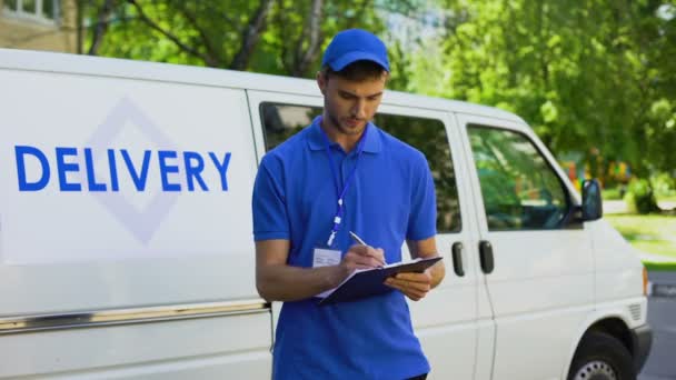 Delivery company worker filling report, student part-time job, fast shipment - Кадры, видео