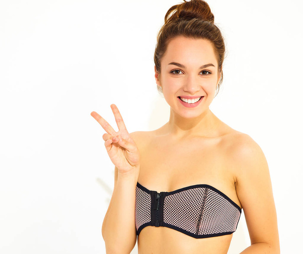 Smiling girl model in casual summer swimwear clothes, showing peace sign - Foto, Imagen