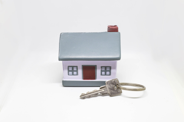 Gümüş anahtar kavramı bir yeni ev Emlak ve mülkiyet kavramı ile minyatür ev - Fotoğraf, Görsel