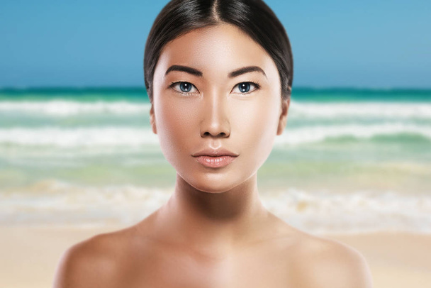 Asian woman with difference in skin brightness. Concept of facial whitening or sun protection.  - Foto, Imagen