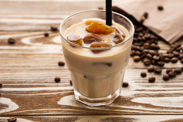 Cold coffee glass with ice cubes on wooden table background. Ice coffee. Copy space. - Fotografie, Obrázek