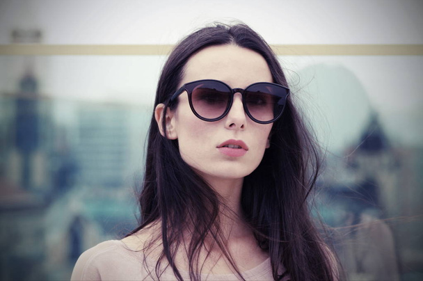 Long-haired brunette woman in large sunglasses - Photo, Image