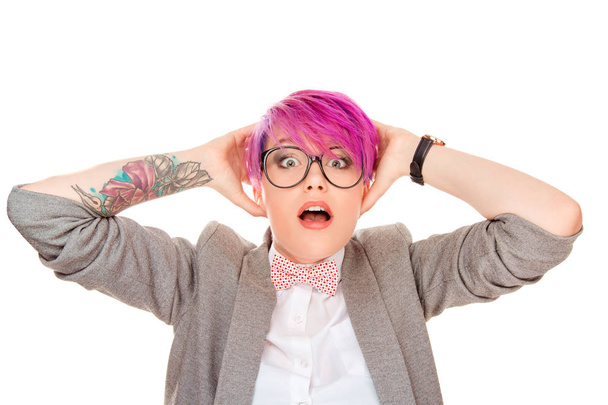 Millennial woman with pink hairstyle holding hands on head and looking stunned with mouth opened at camera isolated on white background - Foto, Imagem
