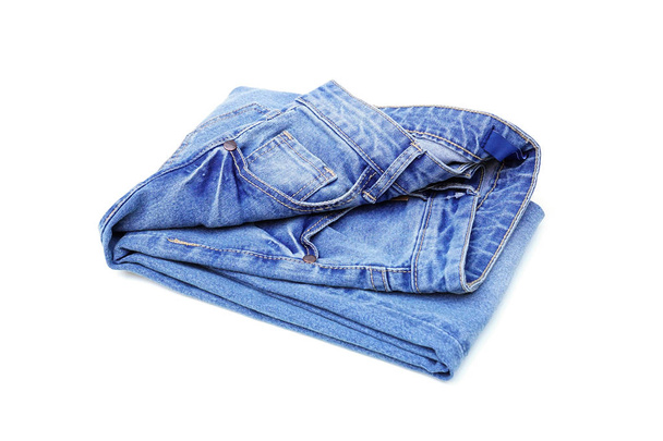 Folded blue denim jeans isolated on white background                             - Photo, Image