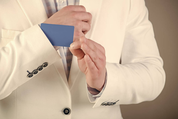 Banking services. Businessman in white jacket on grey background - Fotoğraf, Görsel