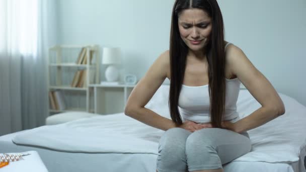 Sick female feeling sharp pain in abdomen, miscarriage danger, induced abortion - Footage, Video